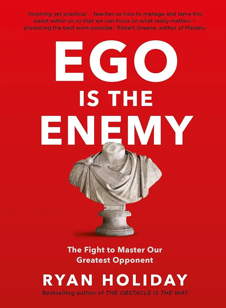 Classical marble bust against a bold red background, symbolizing wisdom and personal growth, on the cover of Ego is the Enemy by Ryan Holiday, conveying themes of self-reflection and internal struggle.