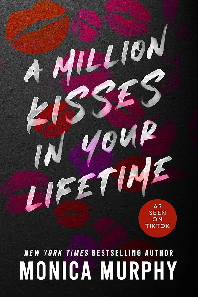 A dark book cover with the title "A Million Kisses in Your Lifetime" in bold white brushstroke font, surrounded by red and purple lipstick kiss marks. At the bottom, it features "NEW YORK TIMES BESTSELLING AUTHOR" and "Monica Murphy" in white text. A red circle on the right says "AS SEEN ON TIKTOK.